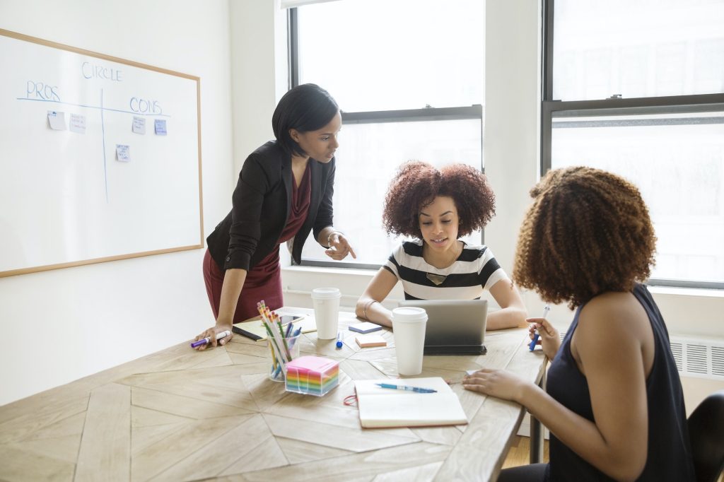 Businesswomen Discussing Strategy In Board Room